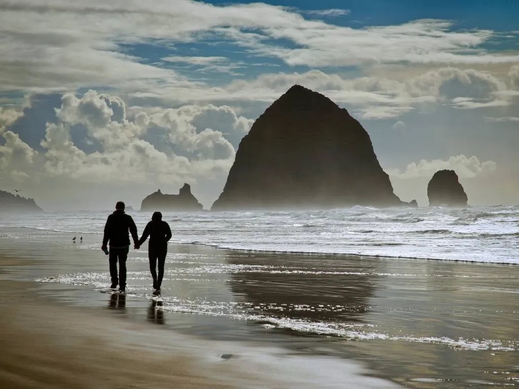 couple walking on Cannon beach.