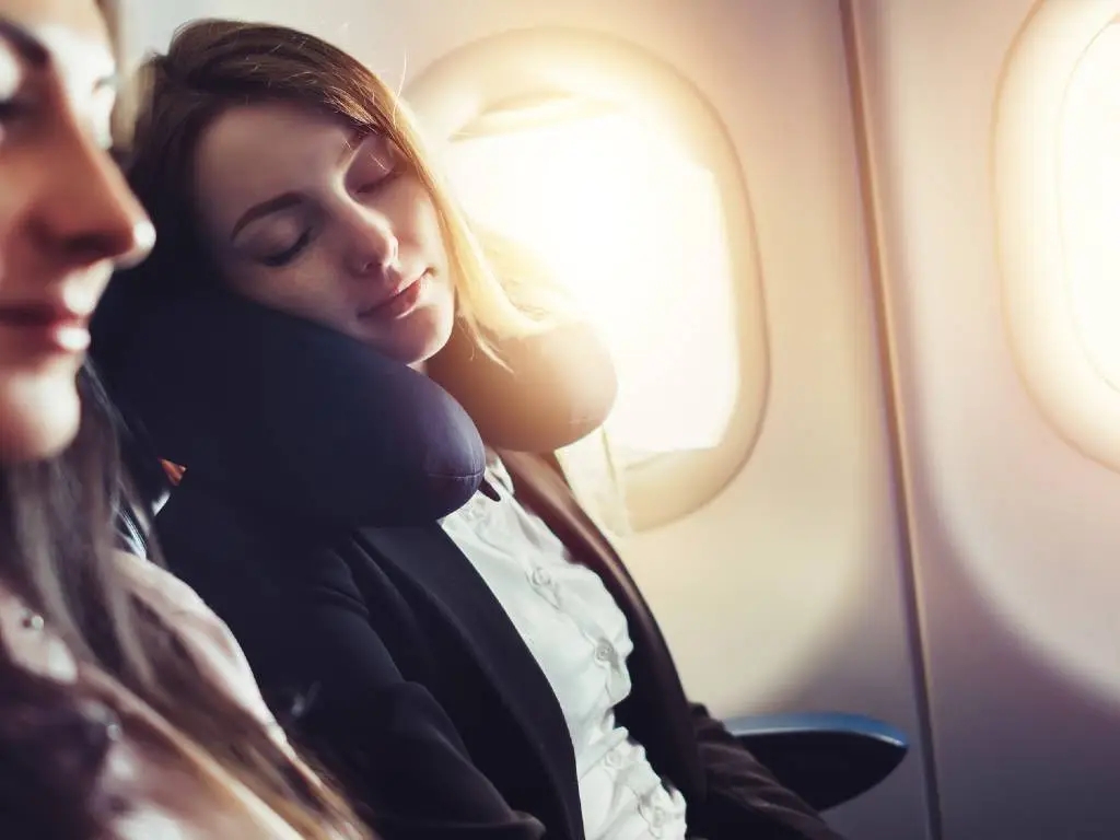 image of woman sleeping on plane