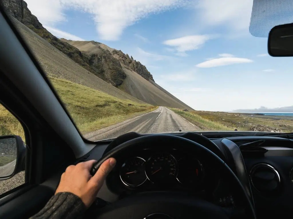 view through driver's window of road in Iceland.