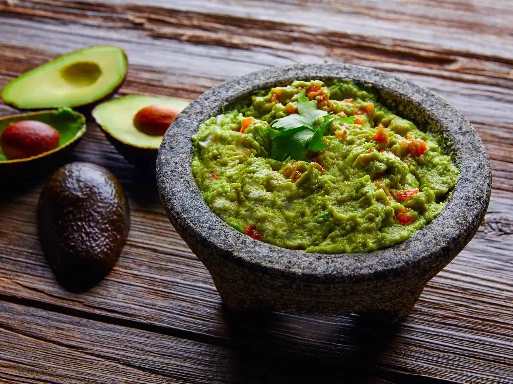 bowl of guacamole in a traditional molcajete